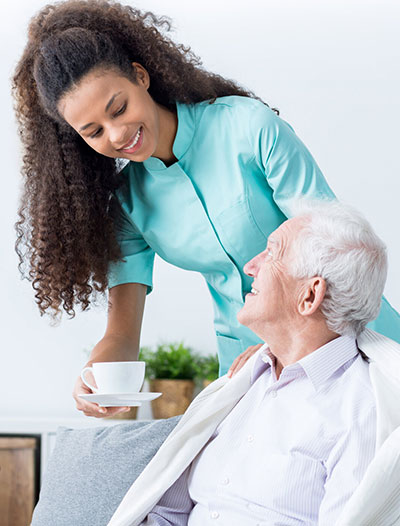 woman helping elderly man